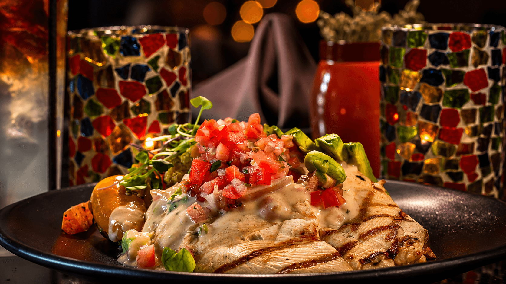 Grilled avocado chicken topped with pico de gallo, tomatillo cream, and micro greens in the cantina