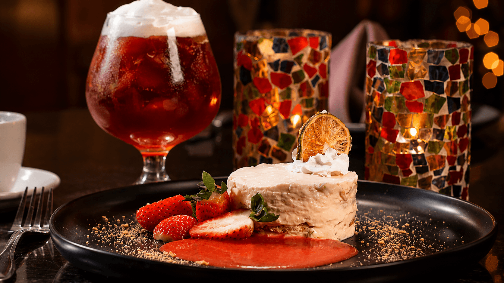 Key lime dessert with fresh strawberries and strawberry coulis, paired with a sangria in the cantina