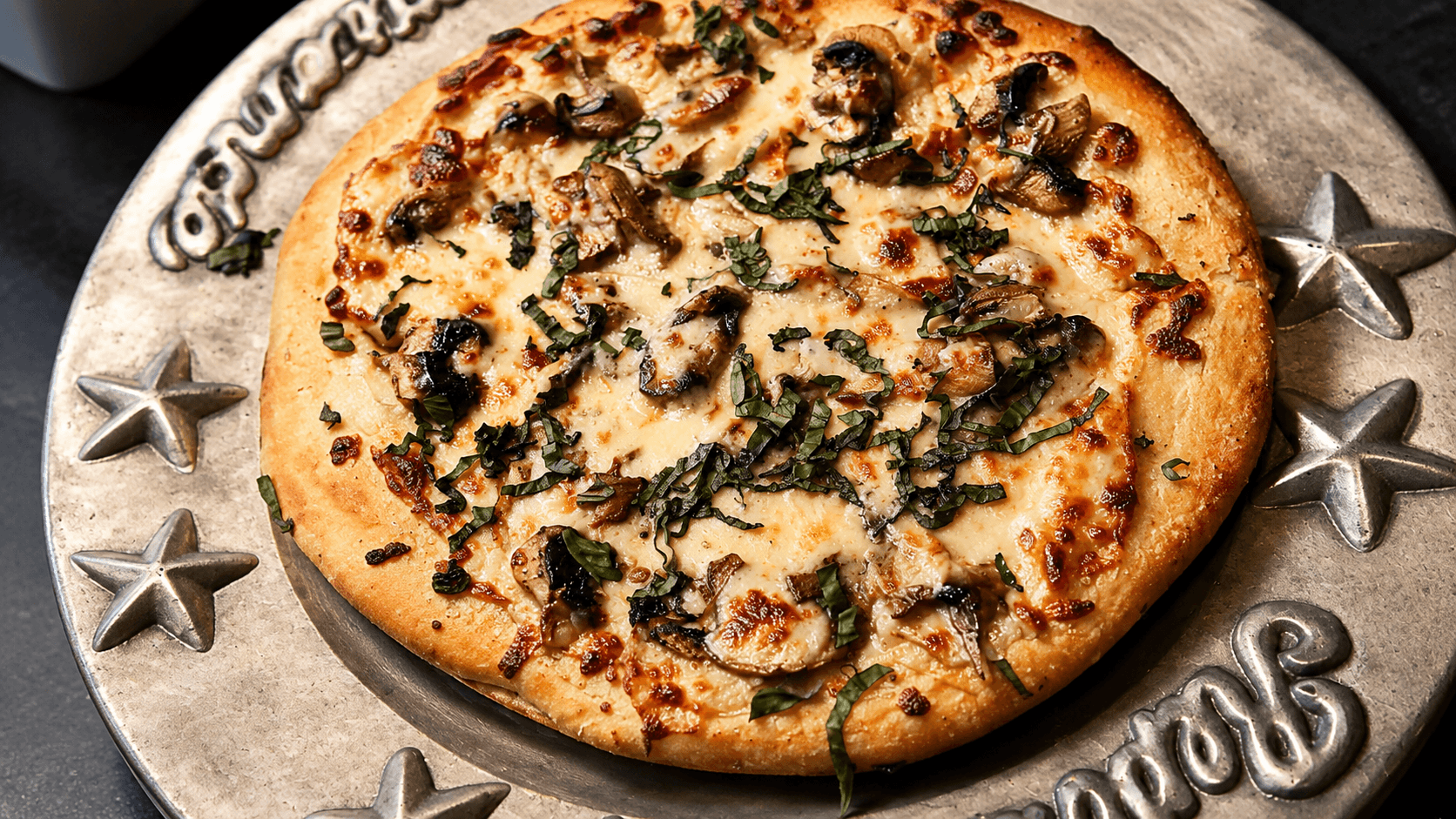 Wild mushroom brick-oven pizza on the branded platter
